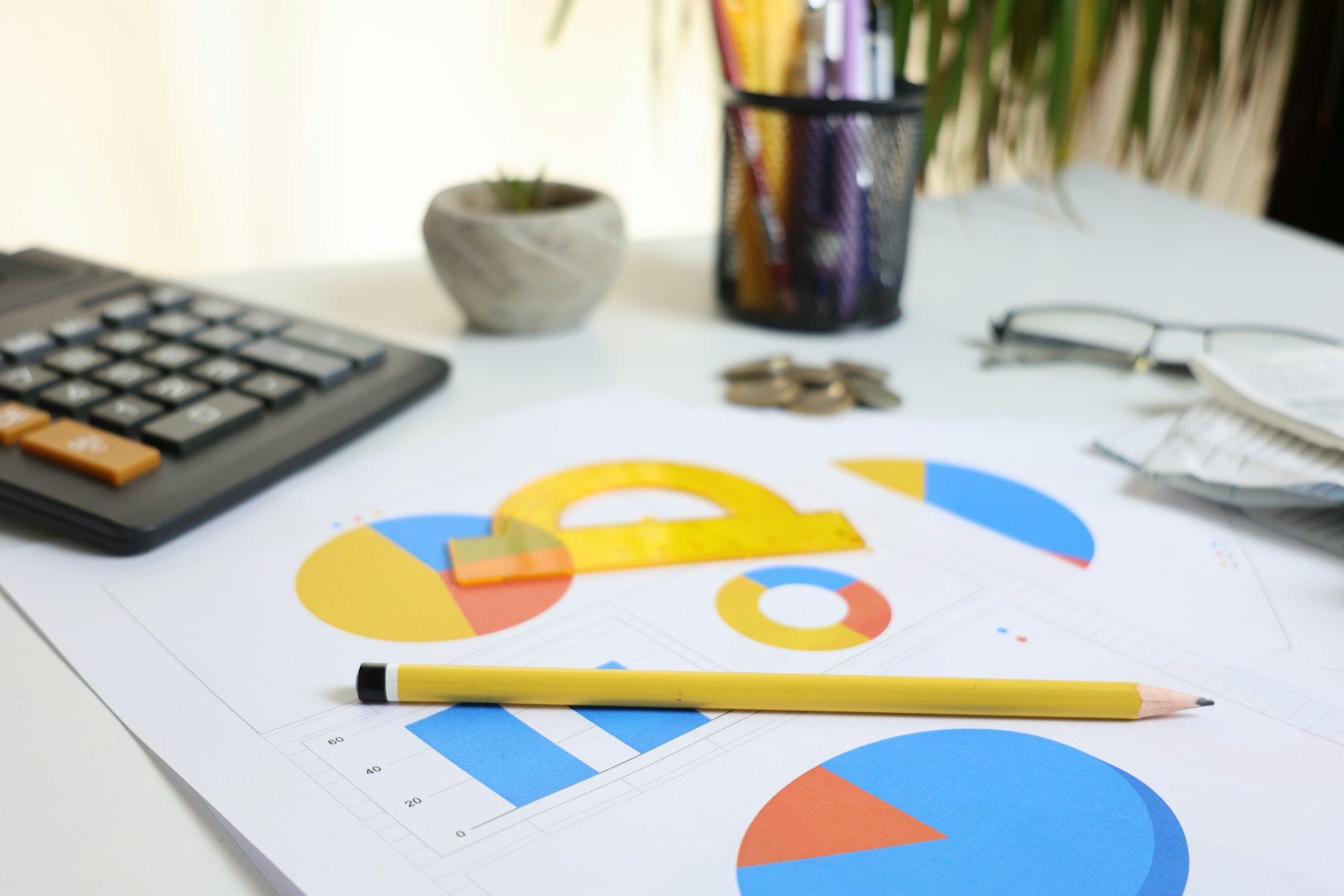 A calculator on printed charts with a pencil